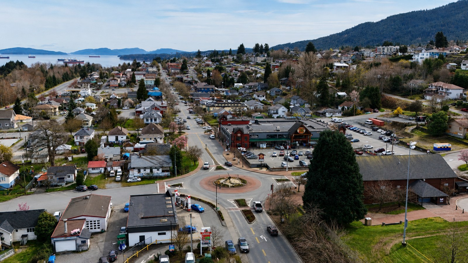 Aerial drone view of downtown Ladysmith, First Avenue, the harbour, nearby neighbourhoods, and surrounding hills